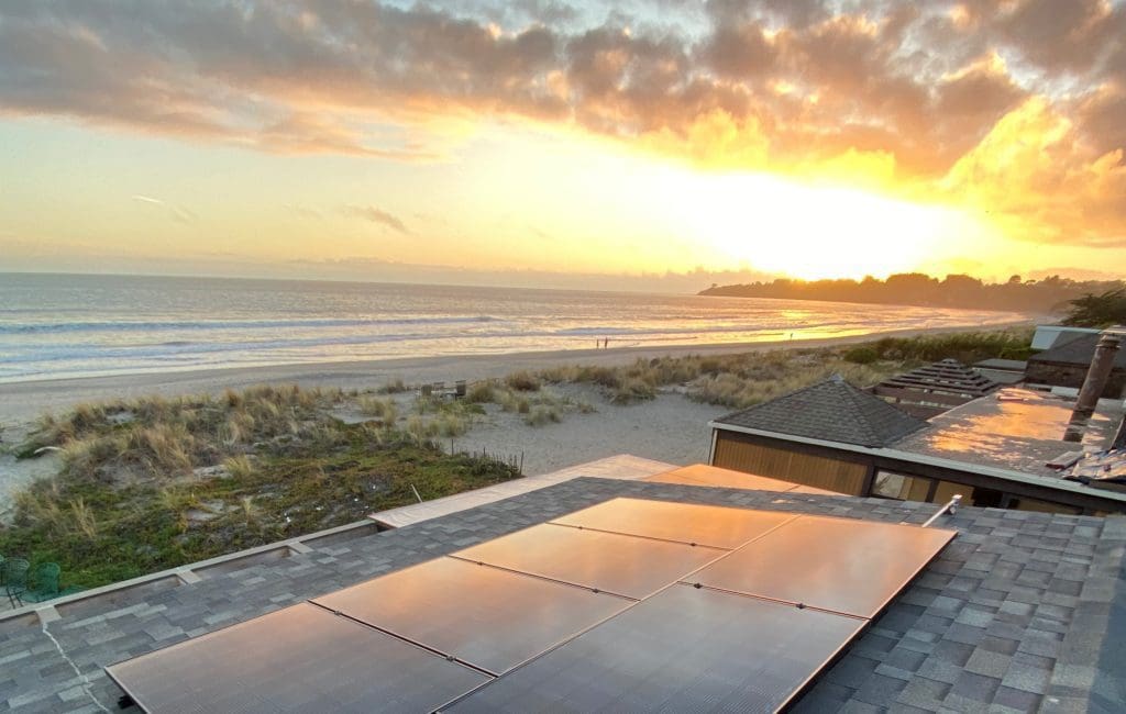 solar panel on roof top near beach with sun setting