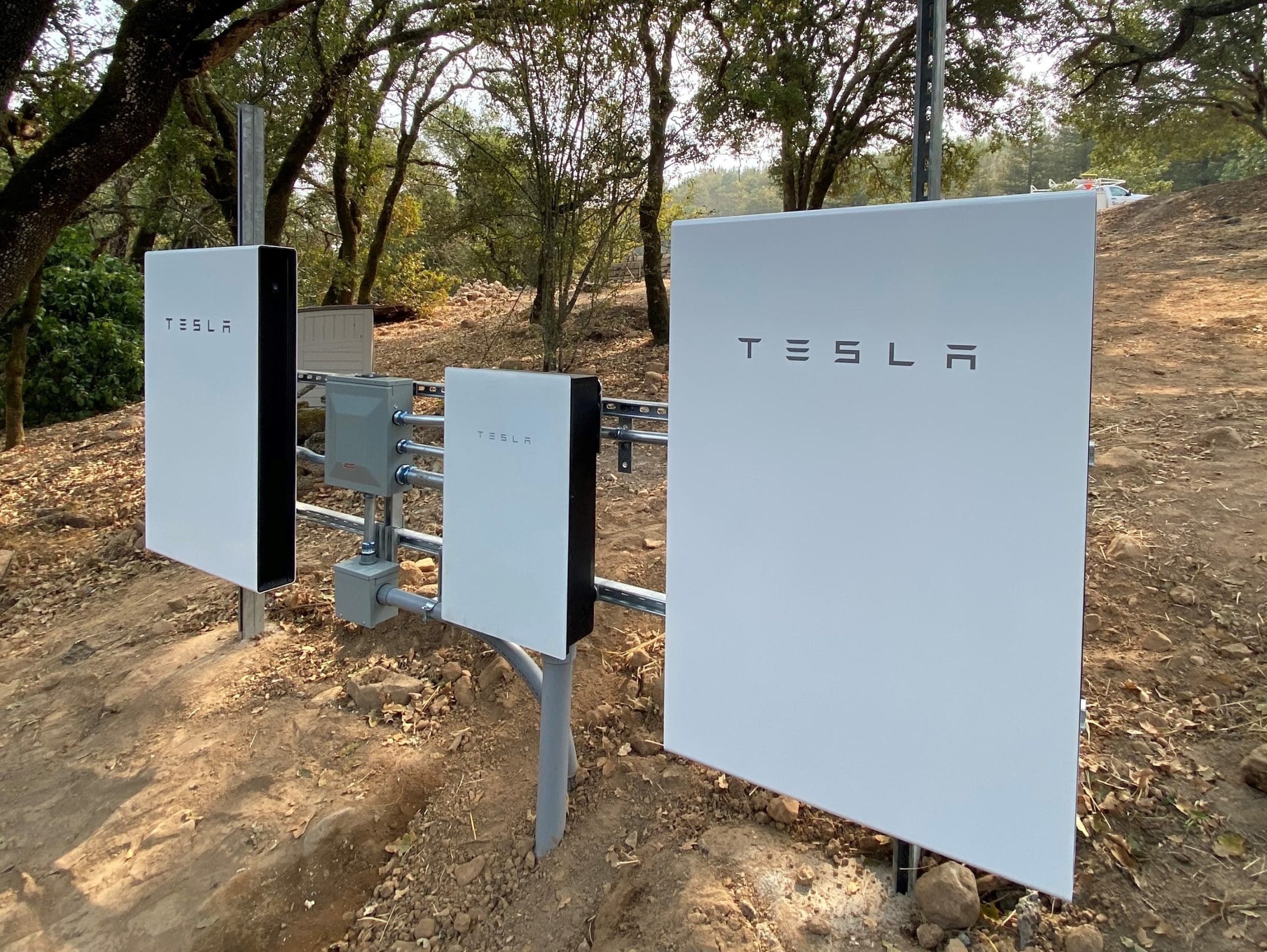 tesla solar batteries under trees