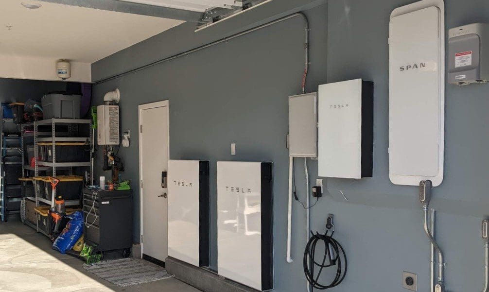 span electric panel and tesla powerwall batteries in a garage