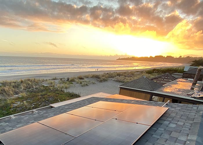 beach house with solar panels on the roof